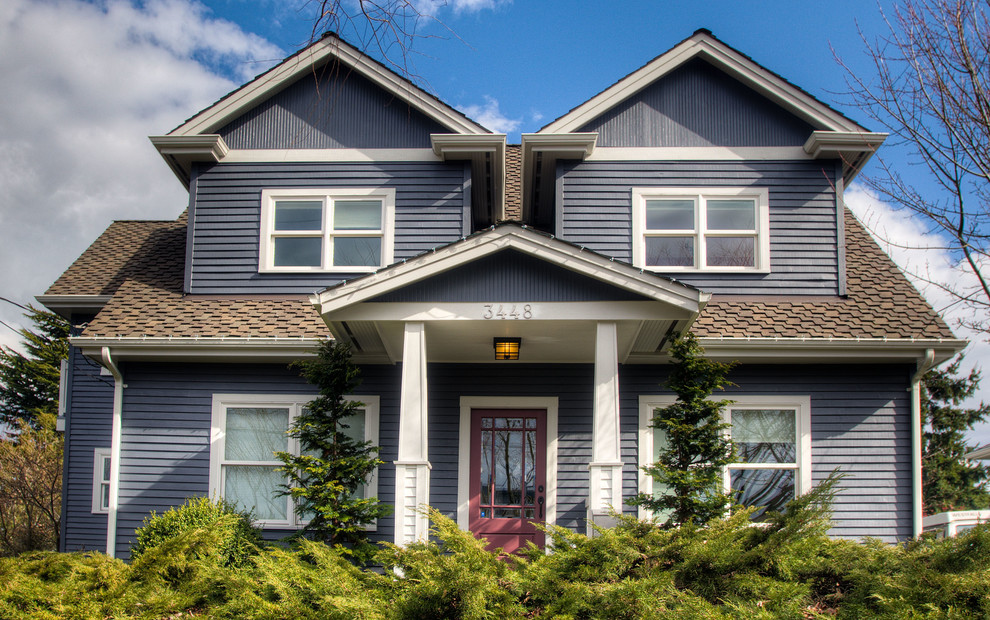 Large and gey classic two floor house exterior in Seattle with wood cladding.