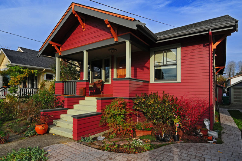 This is an example of a small and red traditional bungalow house exterior in Seattle with wood cladding.