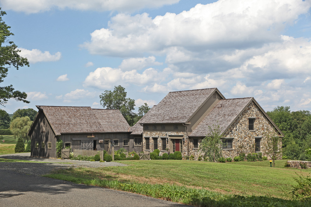 Farmhouse two floor house exterior in New York with stone cladding.