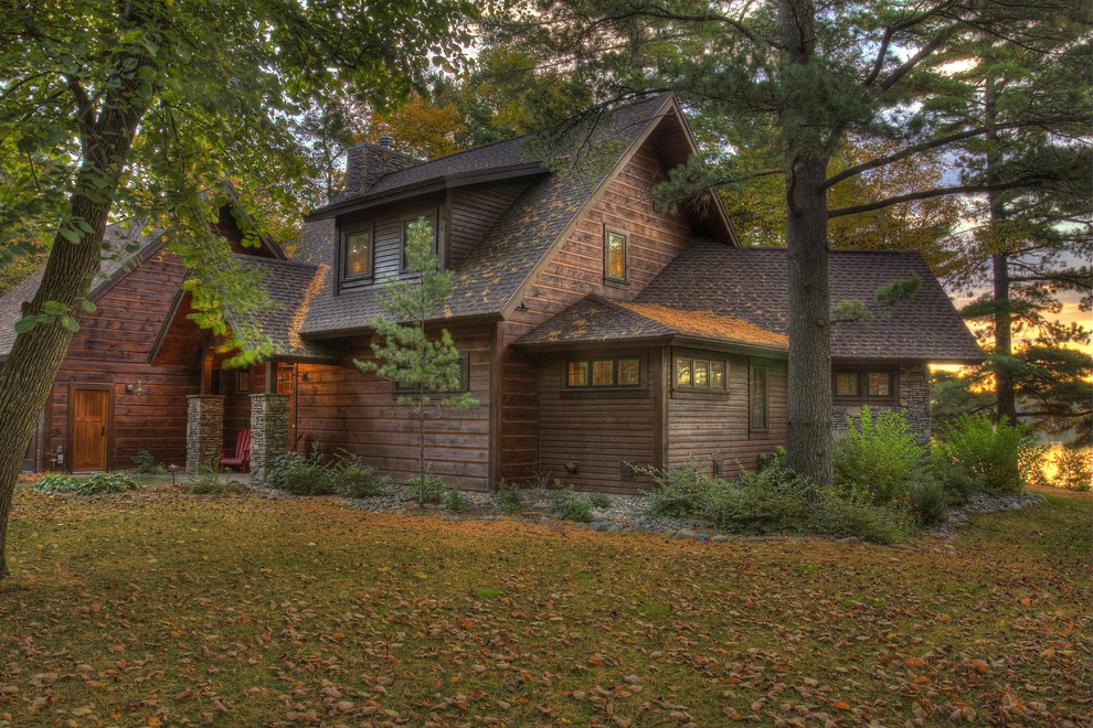 Design ideas for a rustic house exterior in Minneapolis with wood cladding.