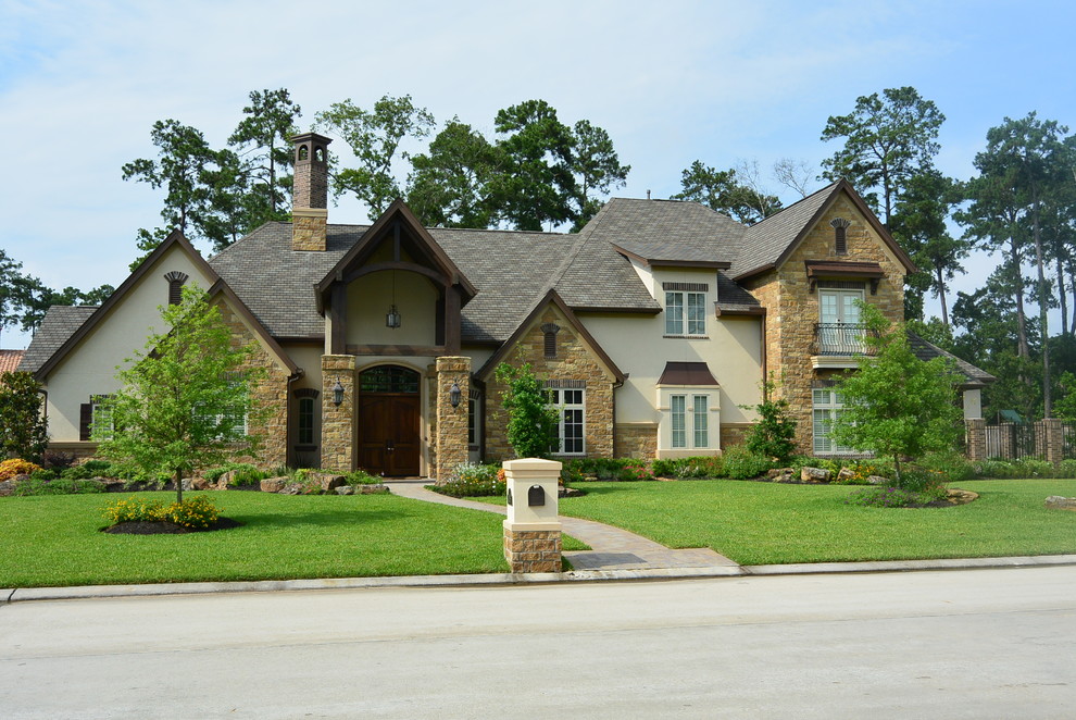 Inspiration for a large rustic multicolored two-story mixed siding house exterior remodel in Houston with a hip roof and a shingle roof
