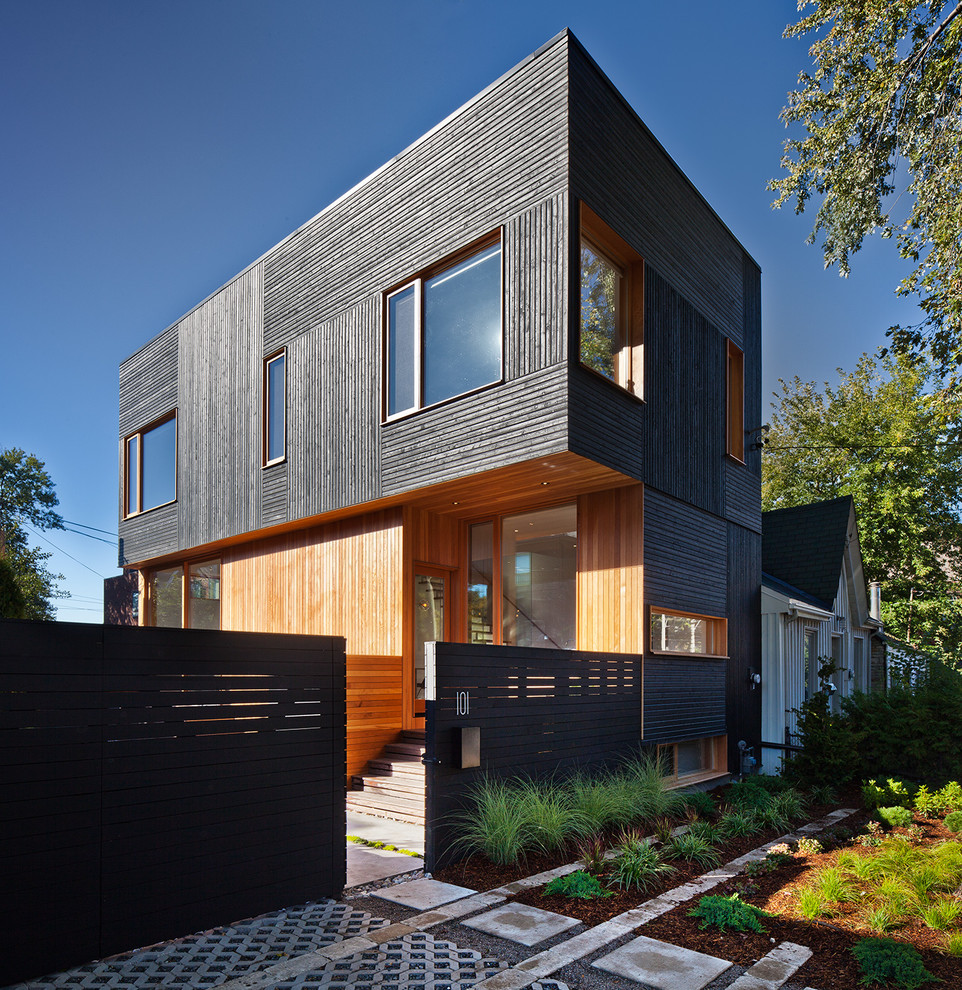 Diseño de fachada negra moderna pequeña de dos plantas con revestimiento de madera