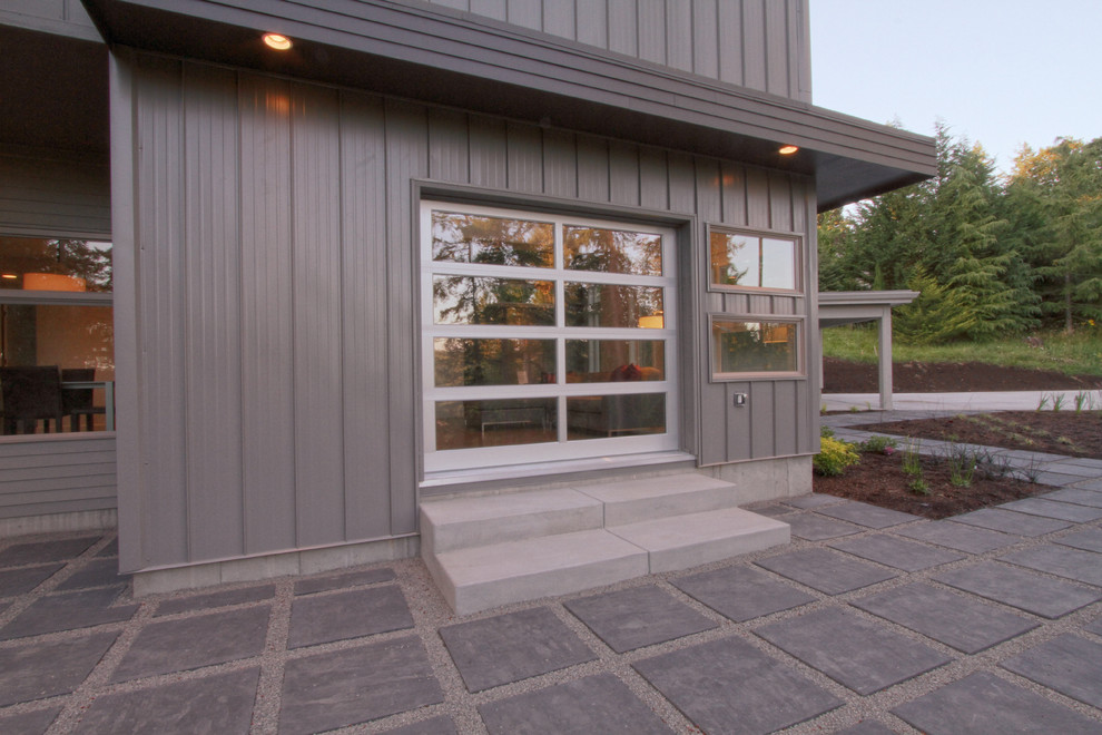 Example of a mid-sized minimalist gray two-story mixed siding flat roof design in Portland