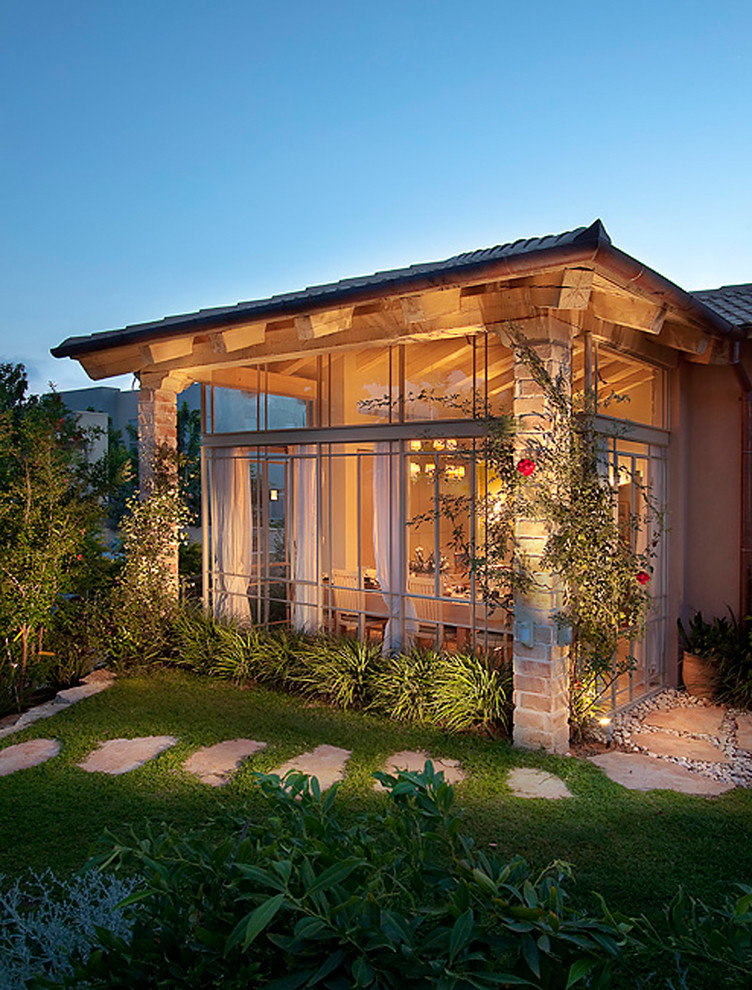 Design ideas for a rustic glass house exterior in Other.