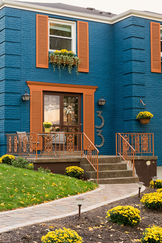 Idee per la facciata di una casa grande blu eclettica a tre piani con rivestimento in mattoni e tetto a capanna