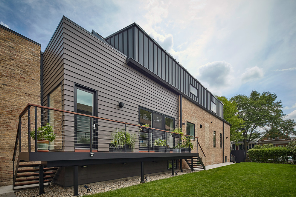 Idee per la facciata di una casa grande nera moderna a due piani con rivestimento con lastre in cemento e tetto a capanna