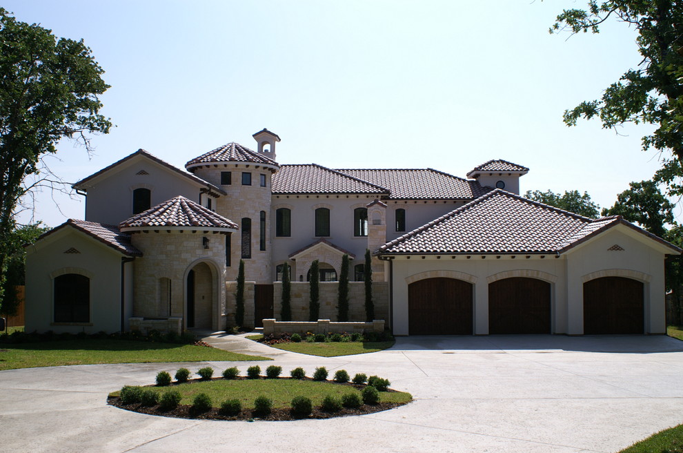 Example of a huge tuscan beige two-story mixed siding exterior home design in Dallas with a hip roof