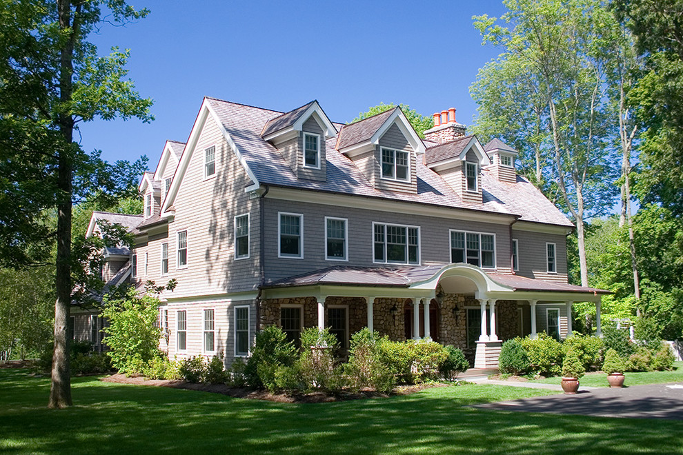 Inspiration for a large timeless gray three-story house exterior remodel in Other