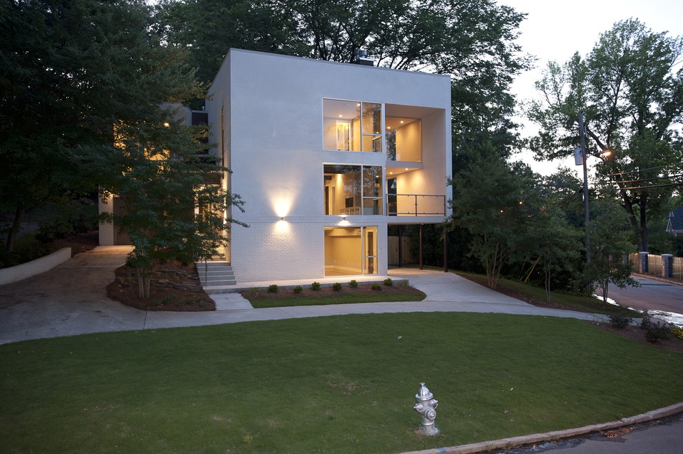 Inspiration for a modern house exterior in Atlanta with three floors.