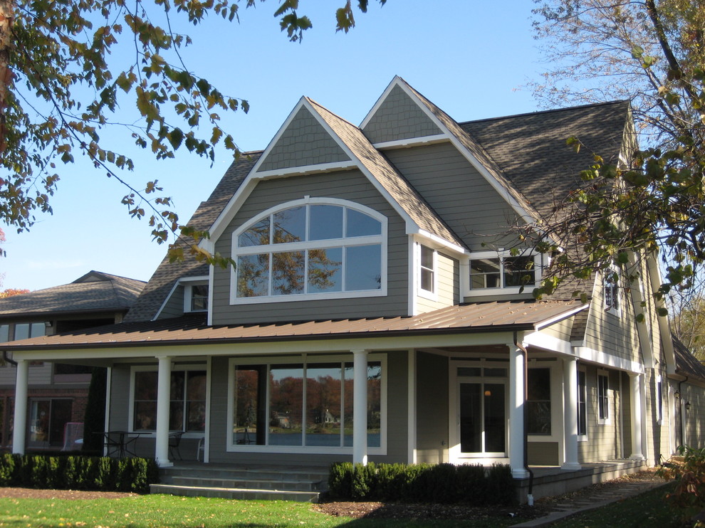 Example of a large classic gray two-story concrete fiberboard house exterior design in Detroit with a shingle roof