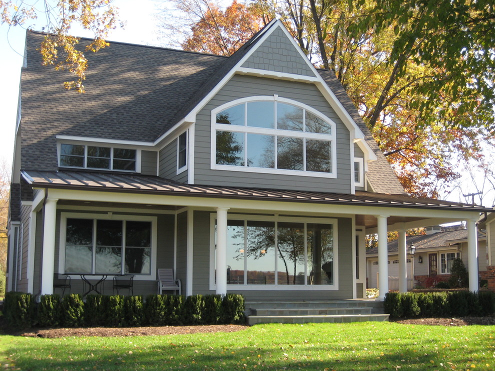 Diseño de fachada de casa gris clásica grande de dos plantas con revestimiento de aglomerado de cemento y tejado de teja de madera