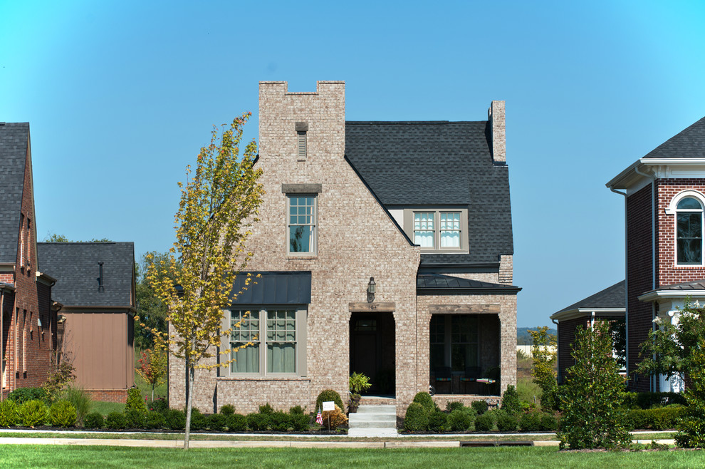 Example of a mid-sized classic two-story brick exterior home design in Nashville