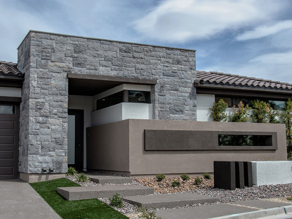 Photo of a large and gey modern two floor house exterior in Las Vegas with stone cladding.