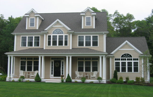 Inspiration for a large timeless beige two-story vinyl exterior home remodel in Boston