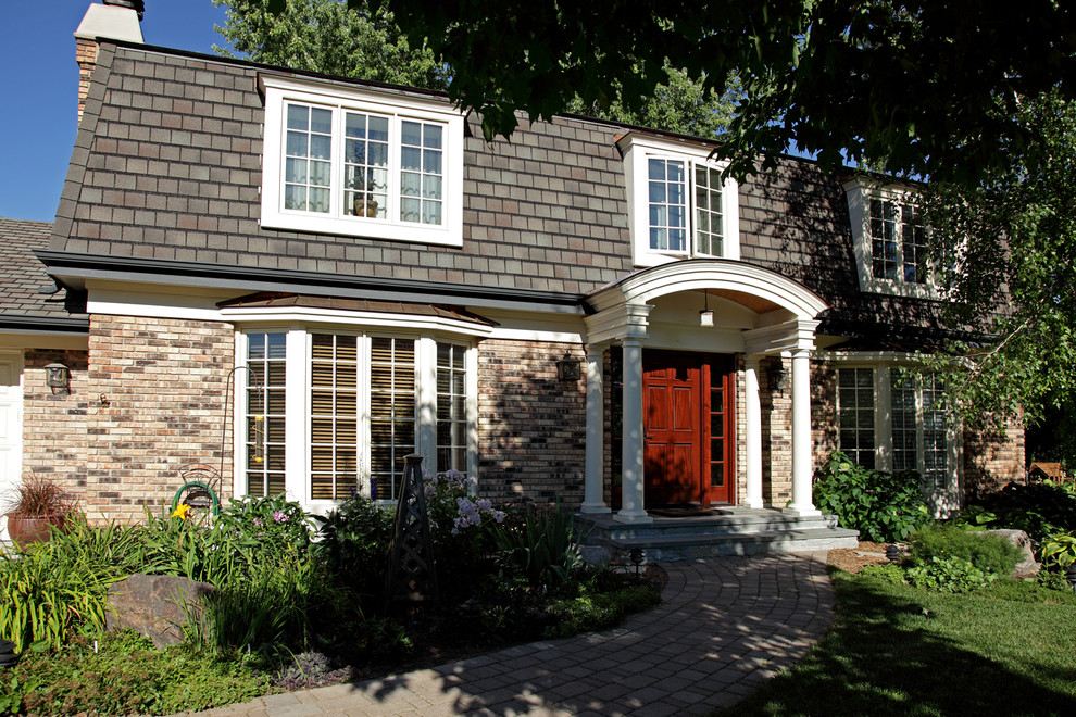 Photo of a medium sized traditional two floor brick house exterior in Minneapolis.