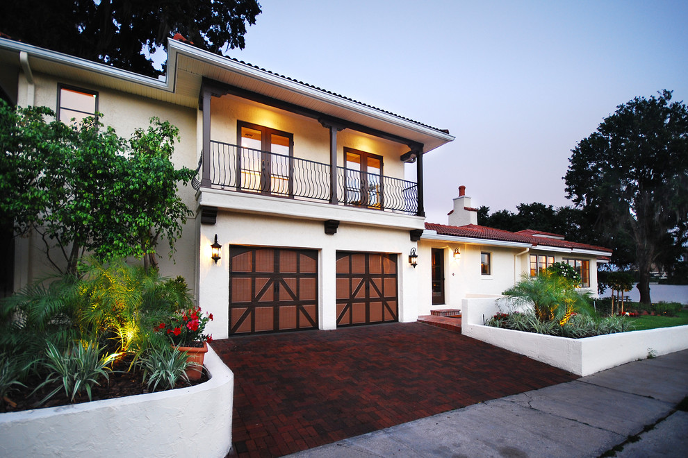 This is an example of a mediterranean two floor house exterior in Orlando.