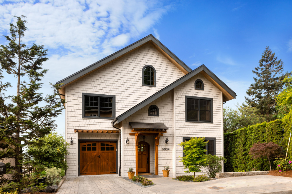 Inspiration for a large timeless gray three-story wood exterior home remodel in Portland with a shingle roof