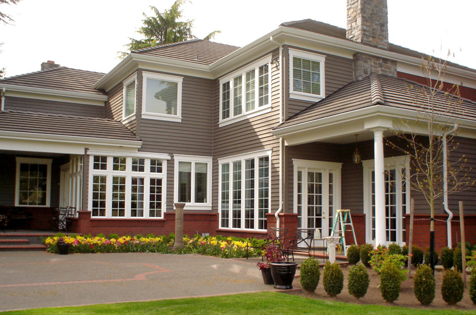 Inspiration for a large timeless brown two-story wood house exterior remodel in Seattle with a hip roof