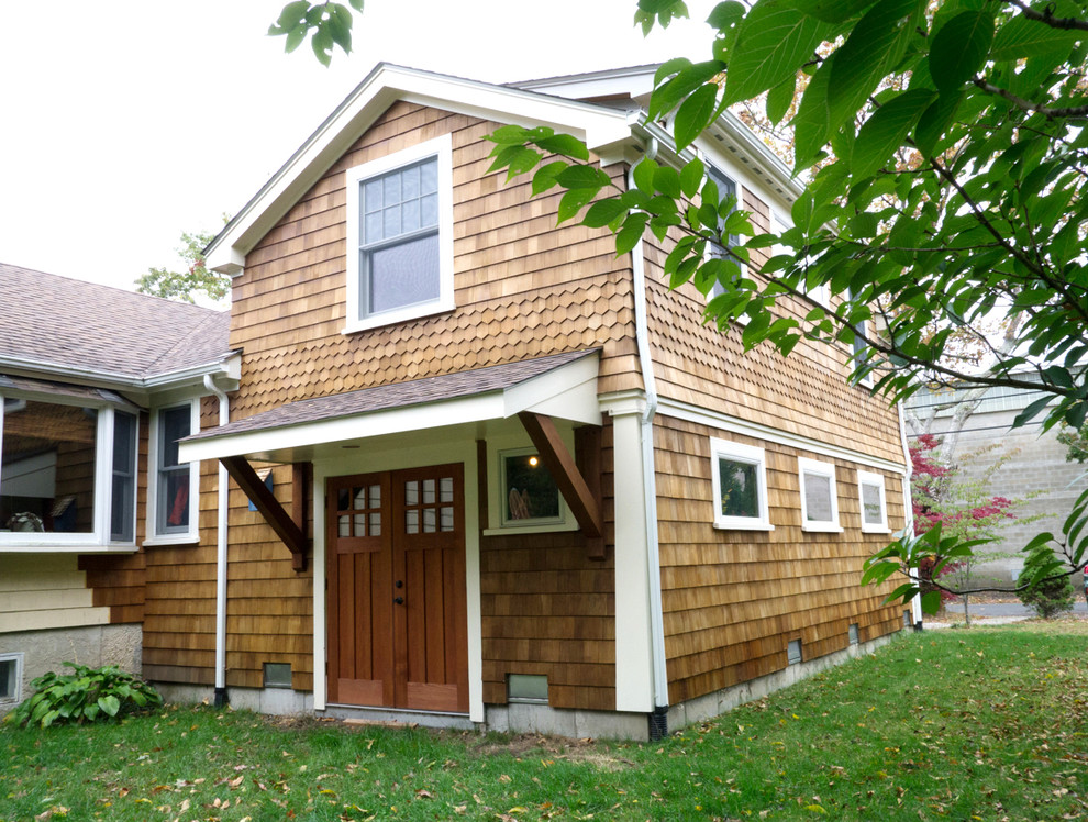Medium sized and brown two floor house exterior in Providence with wood cladding.