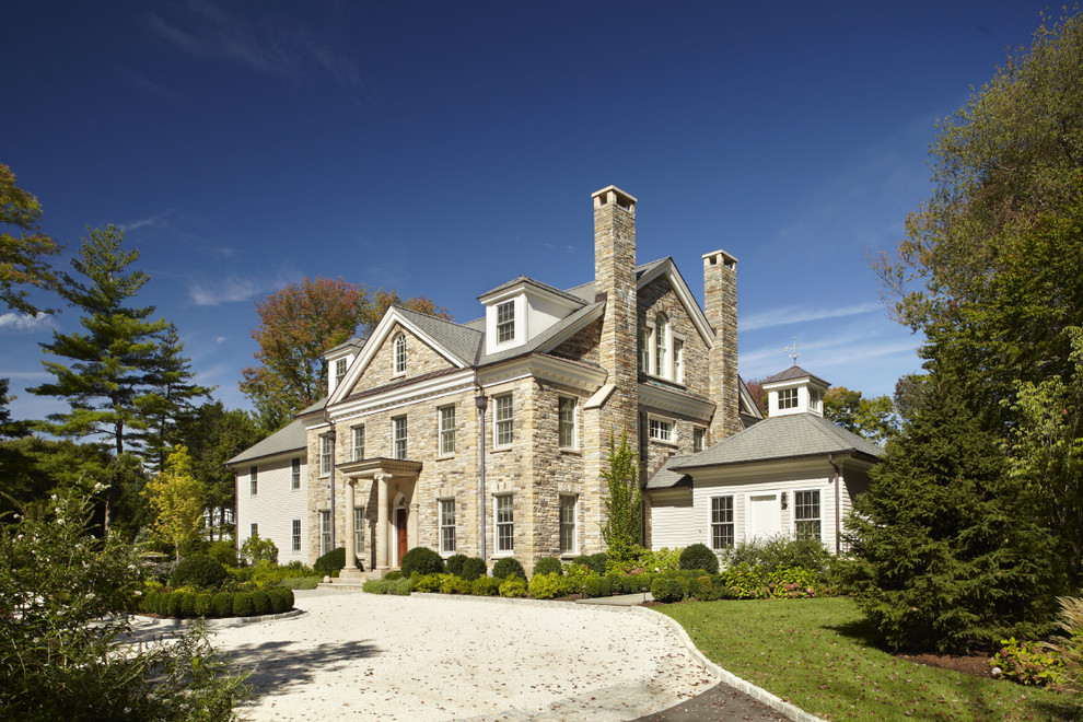 Photo of a traditional house exterior in New York with stone cladding.