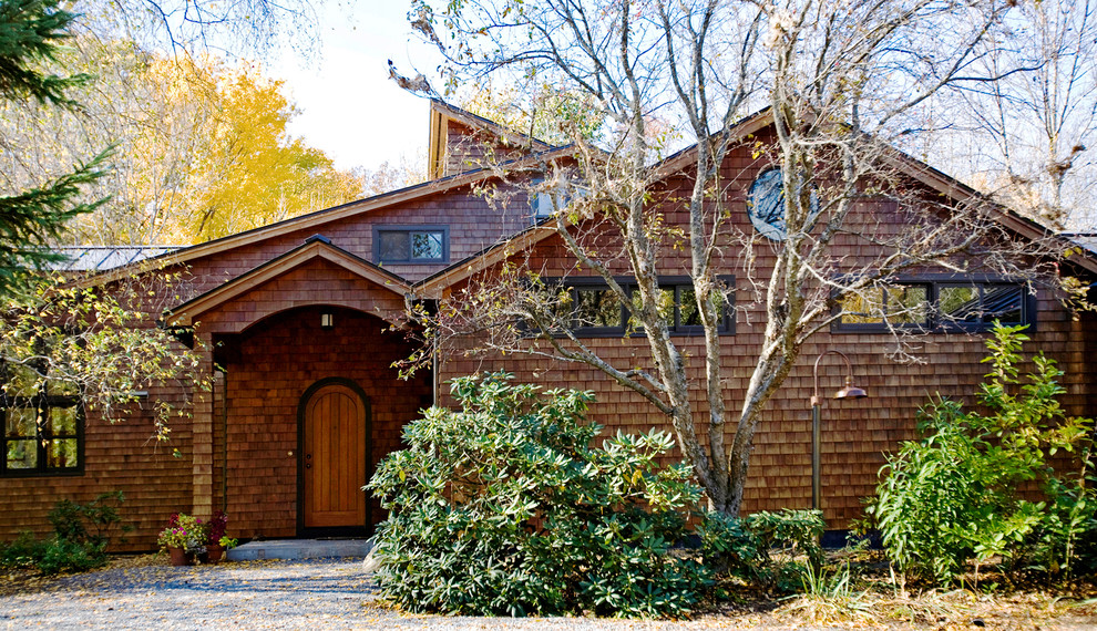 Photo of a rustic house exterior in Burlington with wood cladding.