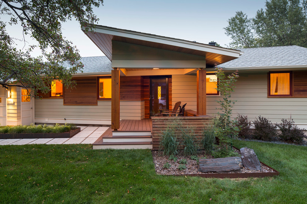 Example of a mid-sized 1960s gray one-story mixed siding exterior home design in Minneapolis with a shed roof