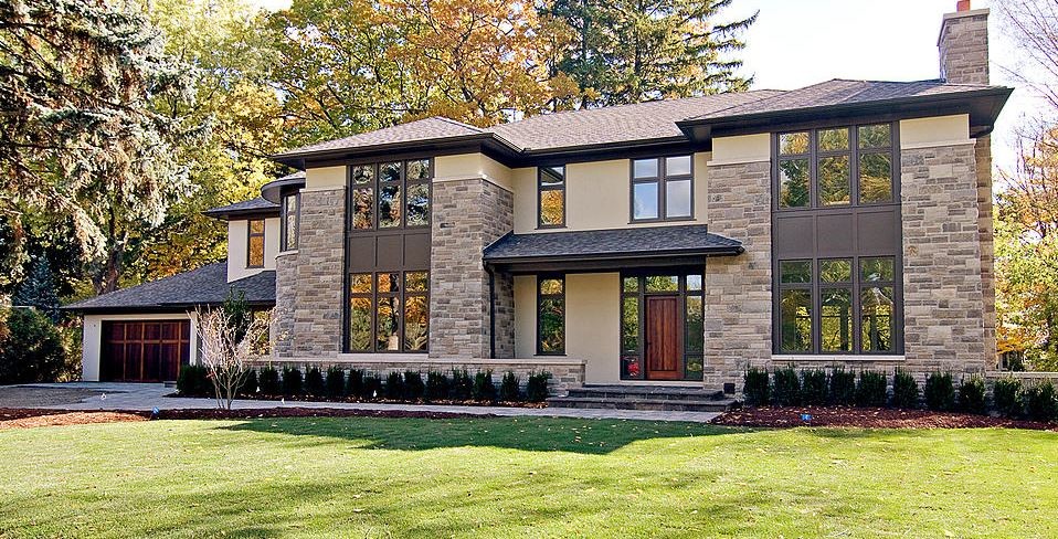 Inspiration for a large and beige classic two floor house exterior in Toronto with mixed cladding and a pitched roof.
