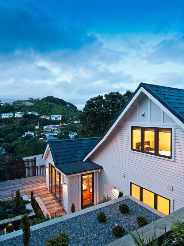 Large and white classic two floor house exterior in Wellington with wood cladding and a pitched roof.