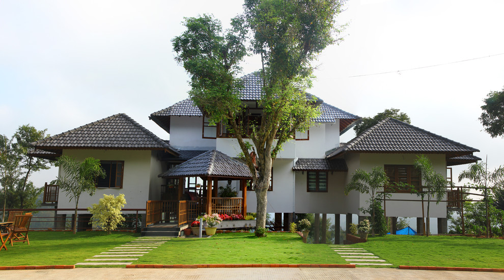 Пример оригинального дизайна: двухэтажный, белый дом в восточном стиле с вальмовой крышей