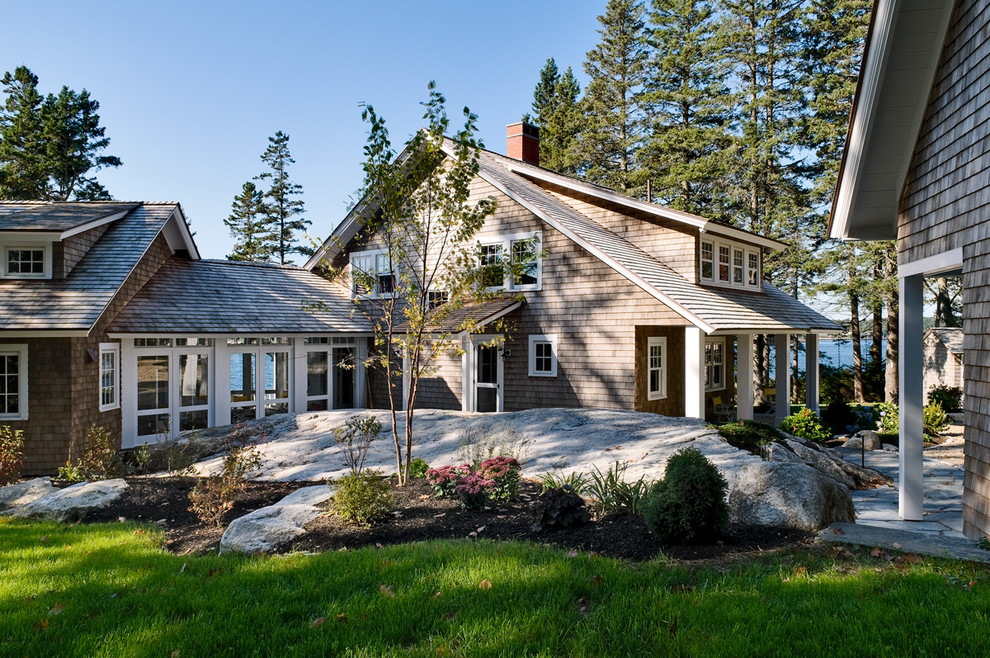 Example of a beach style wood exterior home design in Portland Maine