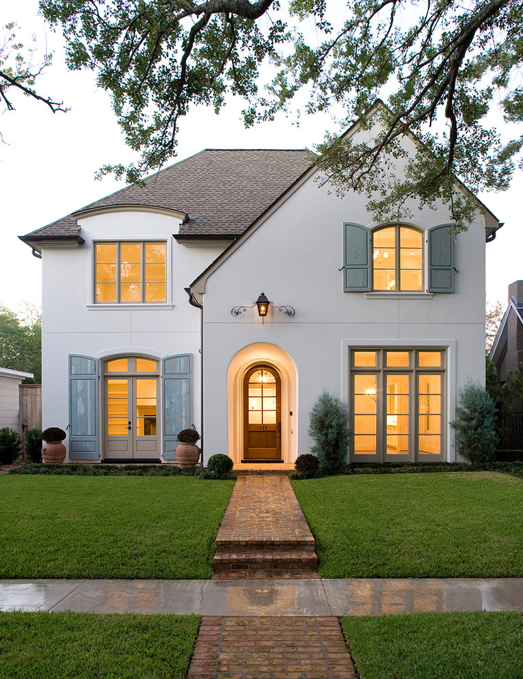 White classic two floor house exterior in Houston with a pitched roof.