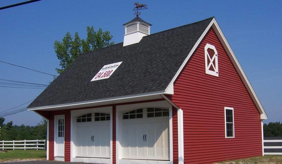 This is an example of a red two floor house exterior in Boston with vinyl cladding.