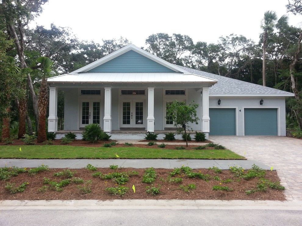 Einstöckiges Maritimes Haus mit Betonfassade, blauer Fassadenfarbe und Satteldach in Orlando
