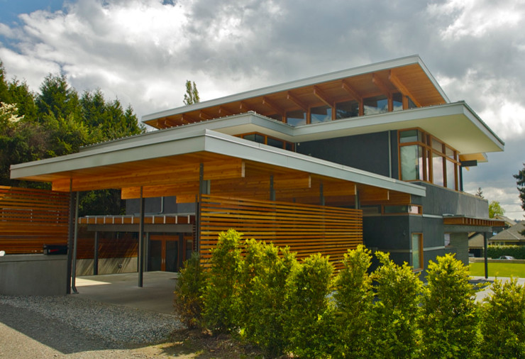 Inspiration for a large contemporary gray two-story glass flat roof remodel in Vancouver