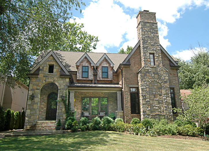 This is an example of a medium sized and multi-coloured classic two floor detached house in Nashville with stone cladding, a pitched roof and a shingle roof.
