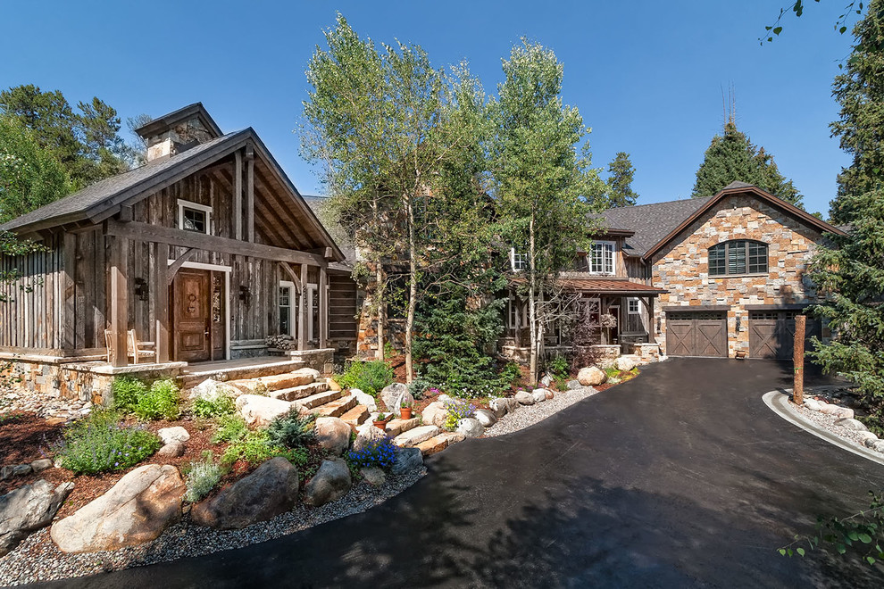 Inspiration for a rustic two-story mixed siding exterior home remodel in Denver