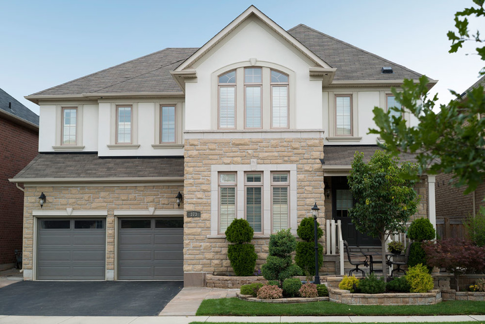 Inspiration for a contemporary beige two-story exterior home remodel in Toronto