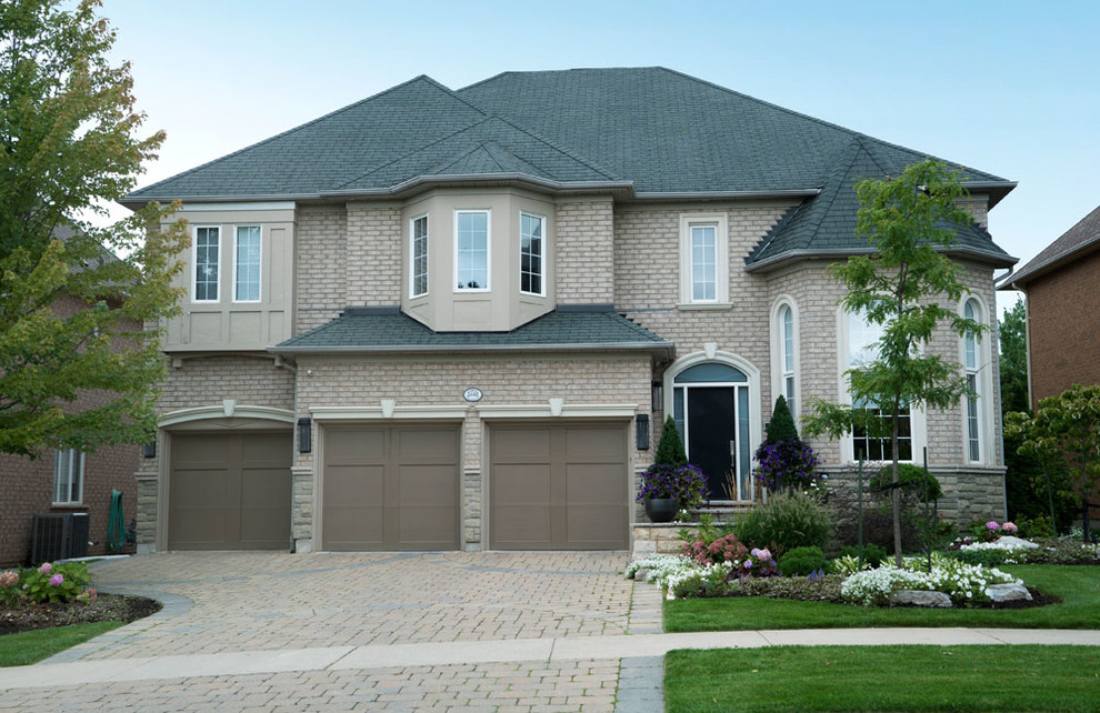 Example of a trendy beige two-story exterior home design in Toronto