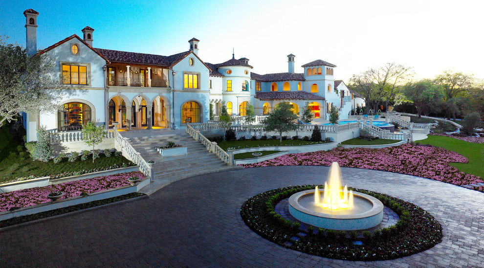 Example of a huge tuscan exterior home design in Dallas