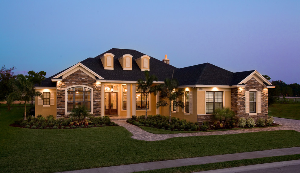 Inspiration for a mid-sized timeless yellow one-story stucco exterior home remodel in Tampa