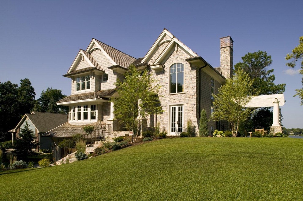 Photo of a traditional two floor house exterior in Minneapolis with stone cladding.