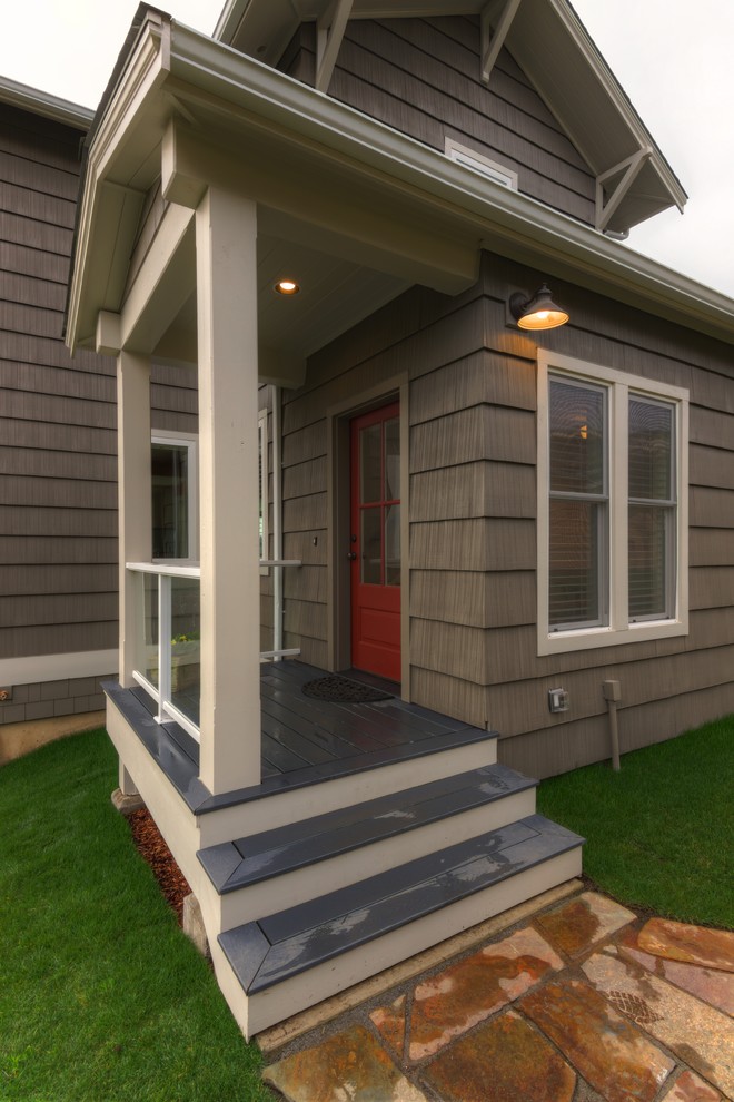 Large craftsman gray three-story vinyl exterior home idea in Seattle with a clipped gable roof