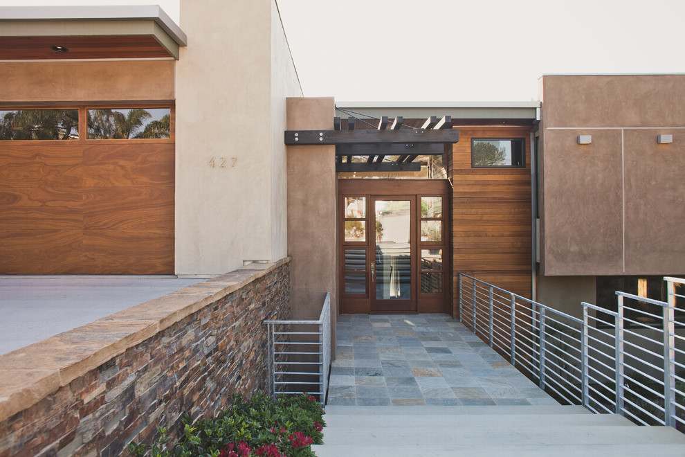 This is an example of a beige modern house exterior in San Diego.