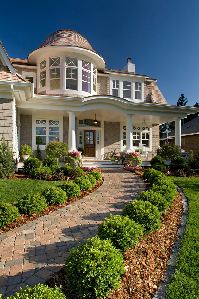 Example of a huge beach style beige two-story wood exterior home design in Minneapolis