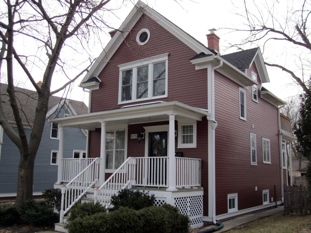 Cette image montre une façade de maison rouge rustique en panneau de béton fibré de taille moyenne et à un étage avec un toit à deux pans et un toit en shingle.