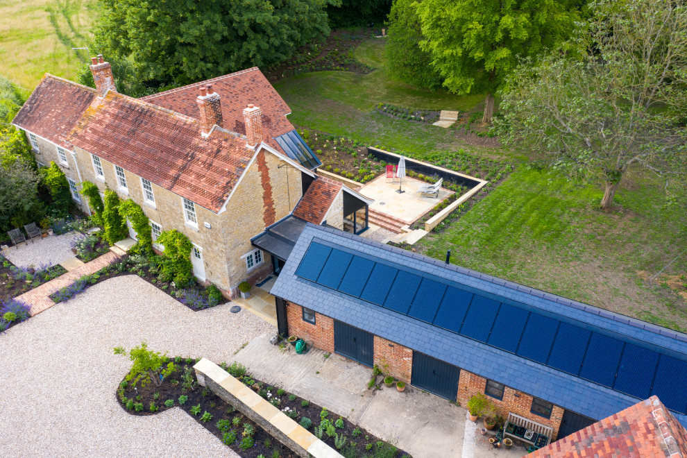 Photo of a farmhouse two floor detached house in Dorset with a mixed material roof.