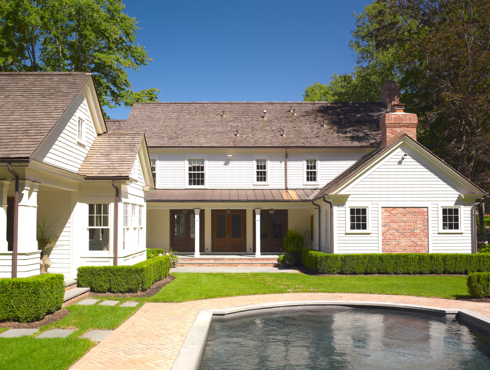 Example of a cottage two-story exterior home design in New York