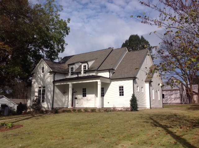 Example of a mid-sized farmhouse white two-story wood gable roof design in Jacksonville