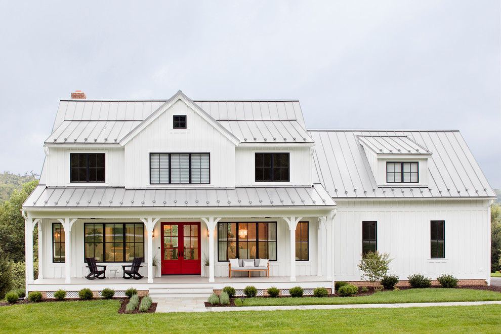 Inspiration for a country white two-story wood and board and batten exterior home remodel in Baltimore with a metal roof