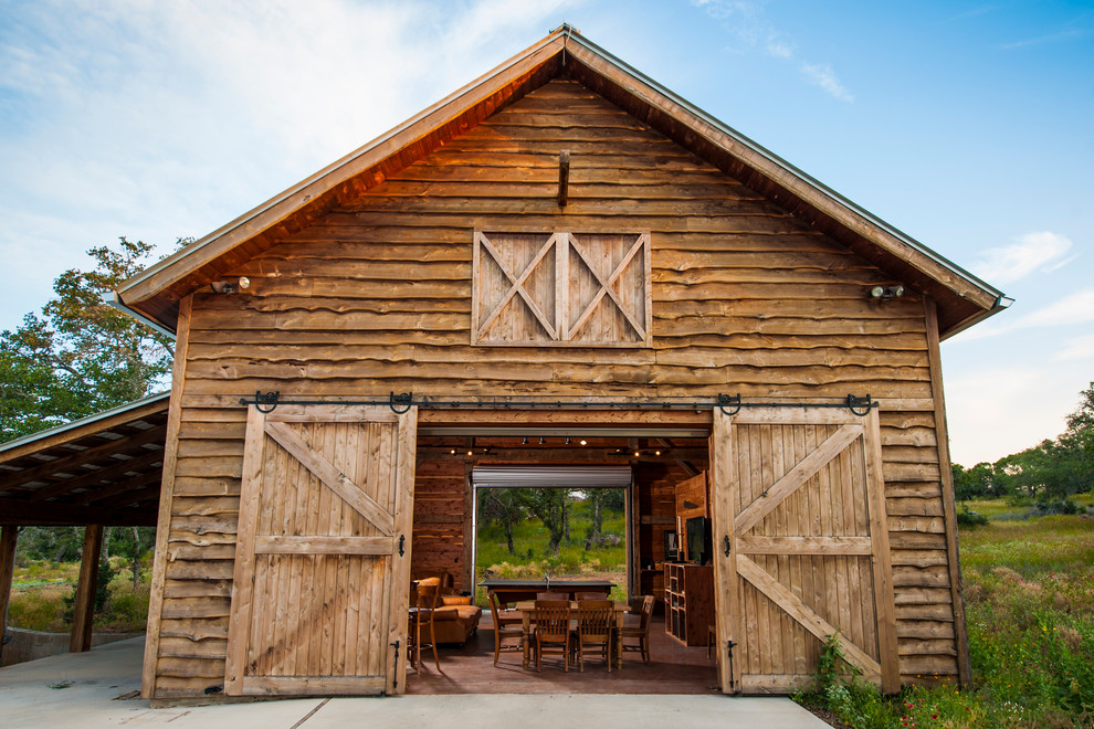 Photo of a country house exterior in Austin with wood cladding.